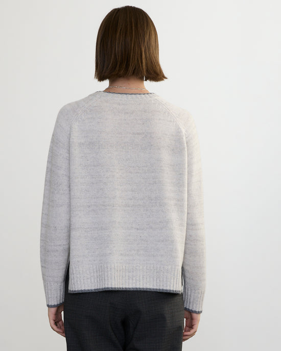A person with short brown hair, seen from behind, is wearing the Margaret O'Leary Mendocino Pullover in Fog Combo and dark pants against a plain white background.