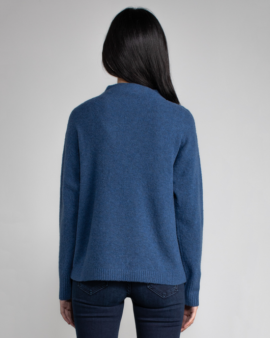 Woman wearing a Margaret O'Leary Charlotte Pullover in Sapphire and jeans, viewed from behind.