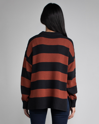 Woman wearing a Margaret O'Leary Chelsea Pullover in Spice Stripe, viewed from behind, showcasing a relaxed fit.
