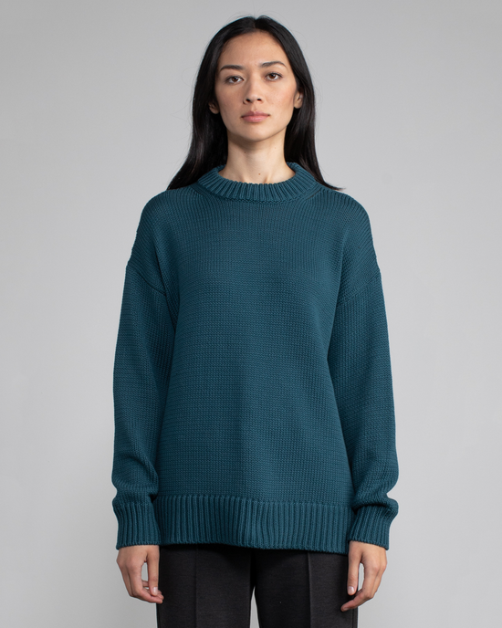 Woman in a relaxed fit, Margaret O'Leary Chelsea Pullover in Pine sweater standing against a neutral background.