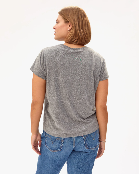 Woman standing with her back to the camera wearing a Clare V Oui Classic Tee in Grey w/ Fern and blue jeans.
