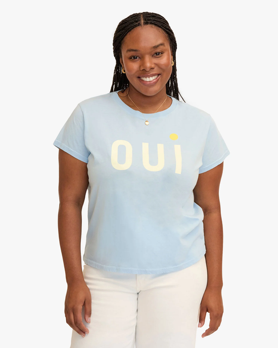 A smiling woman wearing a Light Blue Oui Classic Tee in Light Blue w/ Cream & Yellow by Clare V.