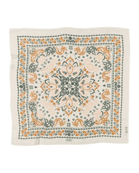 The Mallorca Wool & Silk Bandana in Creme by Maison Lecomte Flament features a square shape, cream hue, and intricate dark green and light orange floral-paisley pattern with decorative borders, inspired by the brand's premium wool scarf designs.