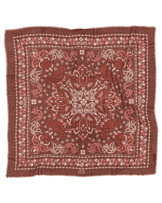 The Saint Emilion Wool & Silk Bandana in Rust by Maison Lecomte Flament features an intricate paisley and floral pattern in red, pink, and white, a central ornate design, patterned borders, and slightly frayed edges for a vintage touch.