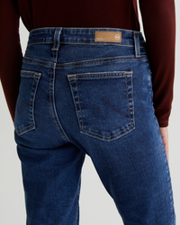 Close-up of a person wearing AG Jeans Mari in 8Ys East Coast high-rise straight leg jeans showing the back pocket design.