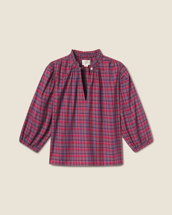 The Orly Blouse in Mulled Wine Plaid by Trovata Birds of Paradis features a ruffled collar, front slit with single button closure, and slightly puffed sleeves with elastic cuffs for a charming look.