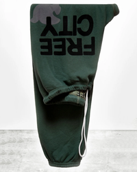 Green hoodie with the text "Superfluff Lux OG Sweatpant in Bush" displayed upside down on a plain background, part of the Free City loungewear matching set.