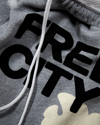 Heather bleachout sweatpant with the word "FREECITY" in black letters and a white drawstring, part of a matching loungewear set.