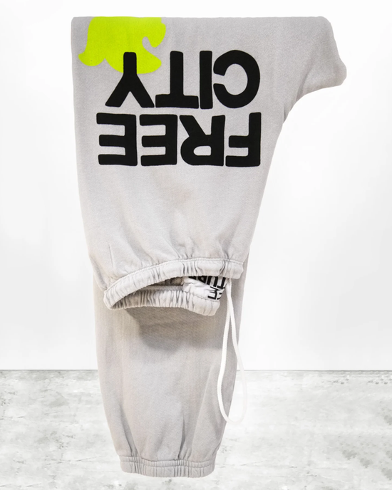 Gray Large Sweatpants in Stardust with inverted "off-white" logo and yellow tag detail, made from French Terry by Free City.