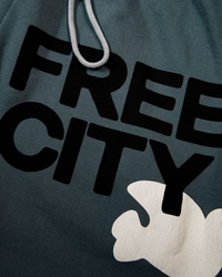 Close-up of a French Terry fabric with the text "Free City" printed on it along with a graphic of a white dove.