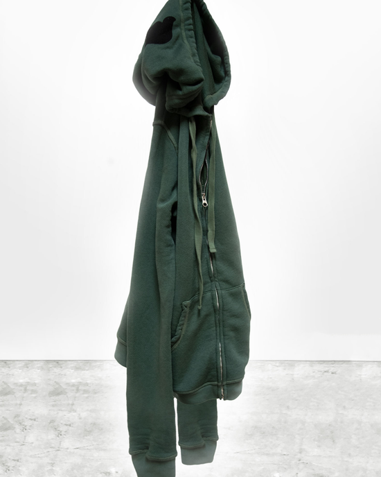 A green Free City Superfluff Lux Zip Hoodie in Bush, made from a promodal/cotton blend, displayed on a mannequin with its hood up against a white background.