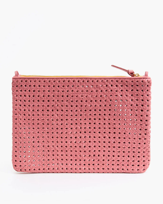 Pink Rattan Flat Clutch w/ Tabs in Petal by Clare V. on a white background.