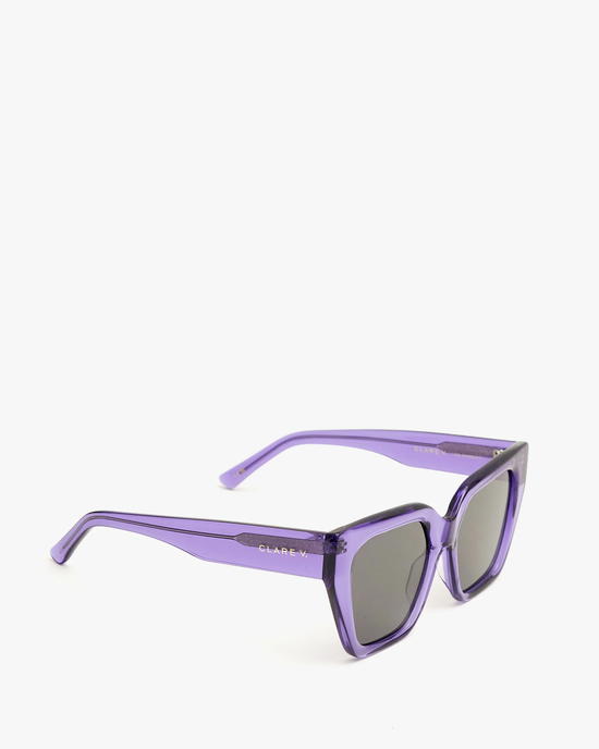 A pair of Iris purple sunglasses with UVA/UVB protection, isolated on a white background.