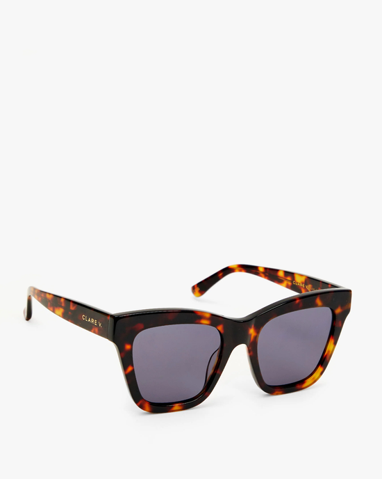 A pair of Clare V. Heather Sunglasses in Tortoise with dark lenses featuring 100% UVA/UVB protection, set against a white background.