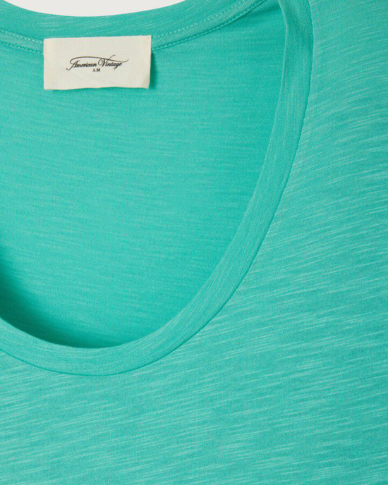 Close-up of a turquoise, short sleeve scoop neck tee with an American Vintage branded label.
