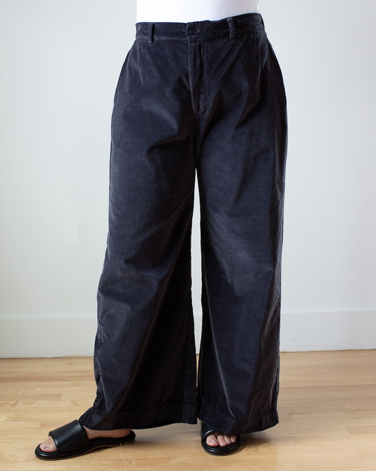Person standing wearing CP Shades Polly Wide Leg Pant - Cotton Velvet in Carbon trousers and black sandals.
