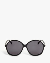 A pair of black oval Clare V. Jane Sunglasses with UV protection against a white background.