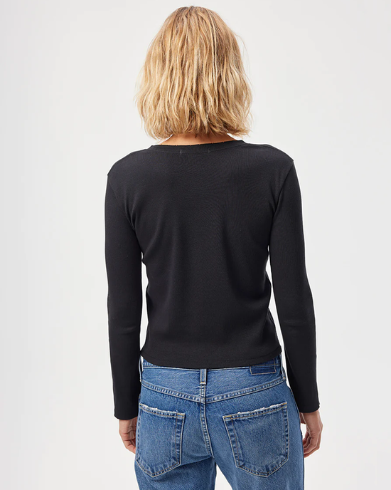 Woman viewed from behind wearing a black AMO L/S Rib Tee and high-waisted blue jeans.
