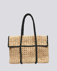 A Maison N.H. Paris Violette Flap Bag in Natural/Noir with black handles on a gray background, crafted from 100% natural raffia.