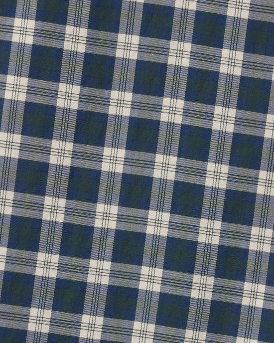 The image shows Trovata Birds of Paradis' Blake Oversized Shirt in Maritime Plaid, featuring blue, white, and black tartan cotton fabric with evenly spaced squares, viewed at a slight diagonal angle.