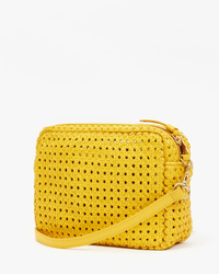 A small, yellow woven Clare V Midi Sac in Dandelion Rattan with a gold zipper and a matching detachable cross-body strap, isolated on a white background.