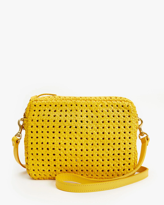 Clare V Midi Sac in Dandelion Rattan with a gold cross-body strap, isolated on a white background.