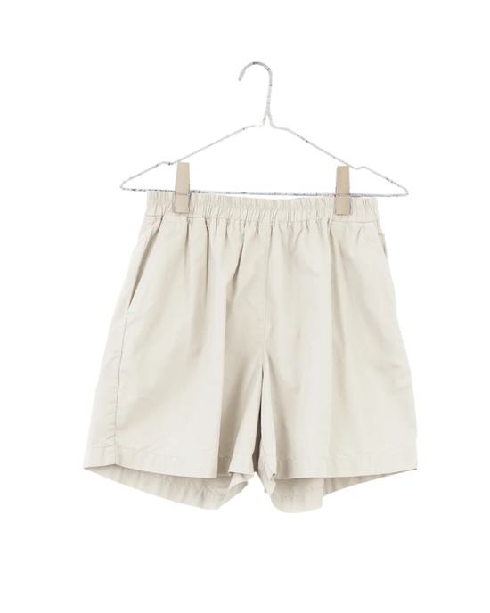 Pair of Everyday Shorts in Natural by It is well LA on a hanger against a white background.
