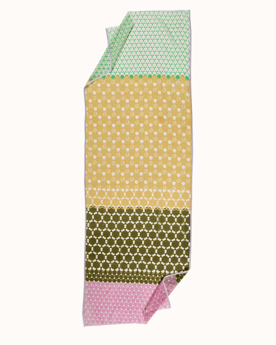 Épice's Dot Panel Scarf in Green is a multicolored patterned handwoven scarf with green, yellow, and pink segments.