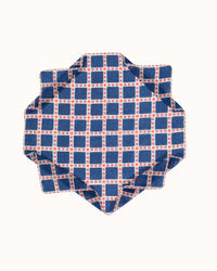 A folded Épice blue Checks Grid Bandana in Blue isolated on a white background.