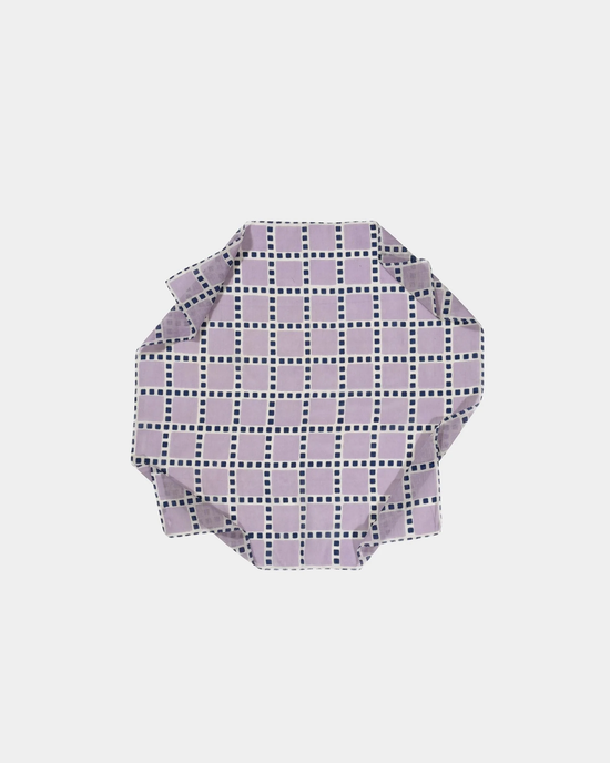 A folded piece of Épice's Checks Grid Bandana in Violet on a white background.