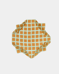 Handwoven Épice Checks Grid Bandana in Gold cloth crumpled on a white background.