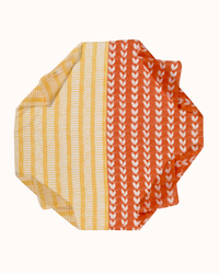 Two folded Épice Small Motifs Bandana in Sunny towels with striped and heart patterns on a white background.