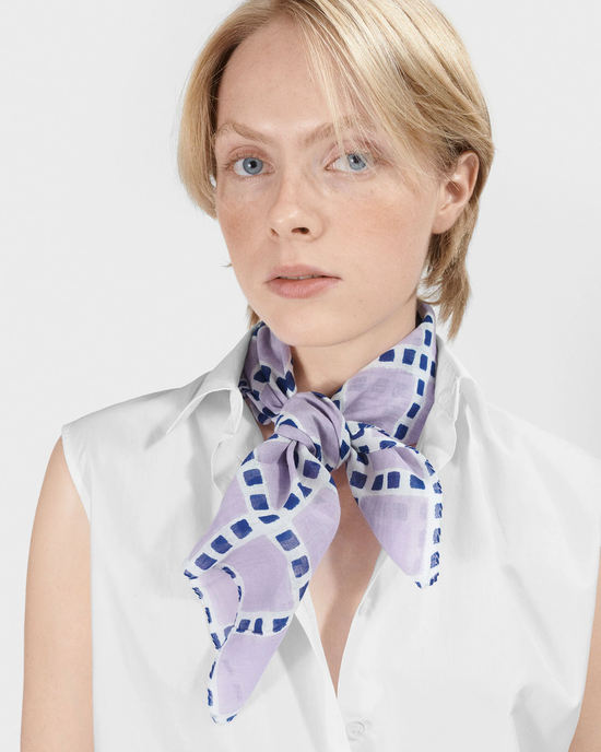 Woman with light hair wearing a white shirt and a handwoven Épice Checks Grid Bandana in Violet neck scarf.