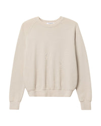 The Alexi French Terry Sweatshirt in Sugar by perfectwhitetee features soft French terry fabric in light beige, designed with a classic crewneck, long sleeves, and ribbed trims, shown against a white background.