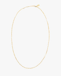 The Clare V. Fine Paperclip Charm Chain 24" in 14K Gold Vermeil features elongated rectangular links and a small oval tag near the clasp, shown on a plain white background.