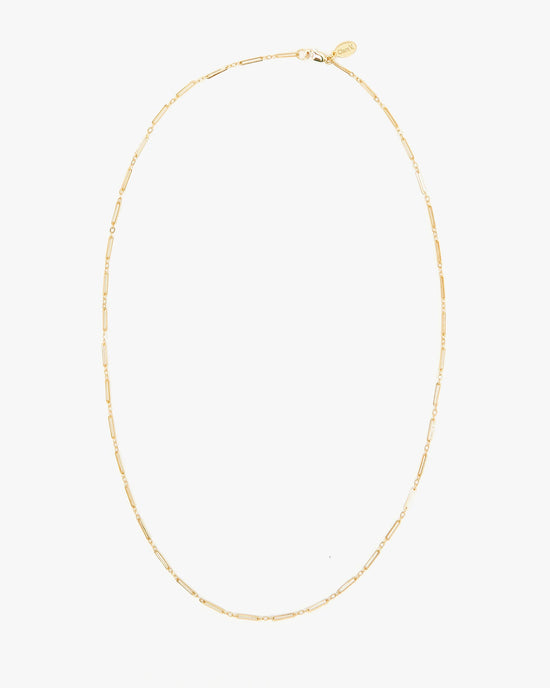 The Clare V. Fine Paperclip Charm Chain 24" in 14K Gold Vermeil features elongated rectangular links and a small oval tag near the clasp, shown on a plain white background.