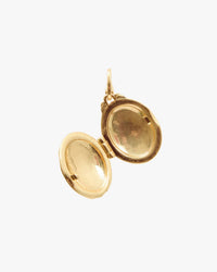 The Clare V. Stripe Locket in Vintage Gold/Black is an oval, gold-plated brass pendant that opens to reveal empty spaces on both sides—ideal for storing small photos or mementos.