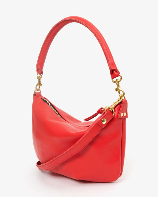 Clare V. Petit Moyen Messenger in Rouge Nappa Luxe shoulder bag with gold-tone hardware isolated on a white background.