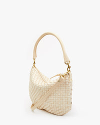 An elegant Clare V. Petit Moyen Messenger - Woven Checker in Cream leather bag with a curved handle, gold hardware, and a detachable shoulder strap, isolated on a white background.