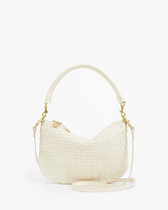 The Clare V. Petit Moyen Messenger - Woven Checker in Cream features gold hardware, a short handle, and a detachable long strap, shown against a plain white background.