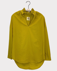 A Shirt Thing Penelope - Cabo - Chartreuse blouse with ruffled collar on hanger against white background.