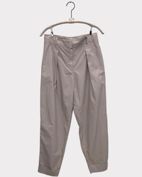 A pair of grey, high-waist pants with front pleats by A Shirt Thing on a wooden hanger against a white background.