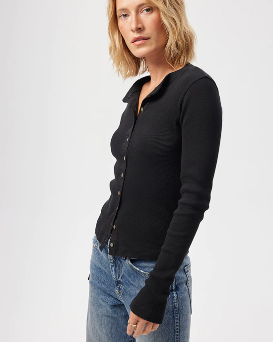 Woman posing in an AMO Lacy Rib Cardigan in Black and blue jeans.