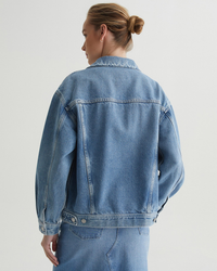 A woman viewed from behind wearing an oversized Hunter Jacket in Chelsea by AG Jeans.