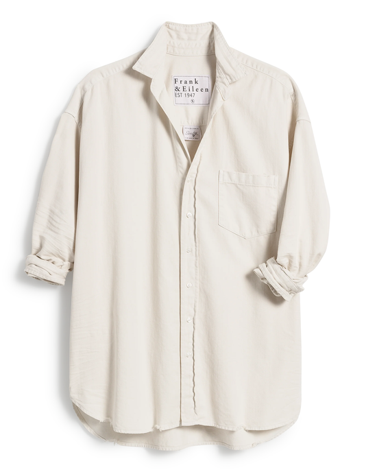 Shirley Oversized Button Up Shirt in Vintage White by Frank & Eileen with rolled-up sleeves and distressed hem on a white background.