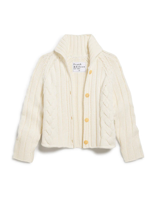 The Mini Cardigan in Ivory by Frank & Eileen is a cream-colored, cropped cable knit sweater with a high ribbed collar and four tan buttons, shown flat and partially open. The inner label displays: Frank & Eileen EST 1947.