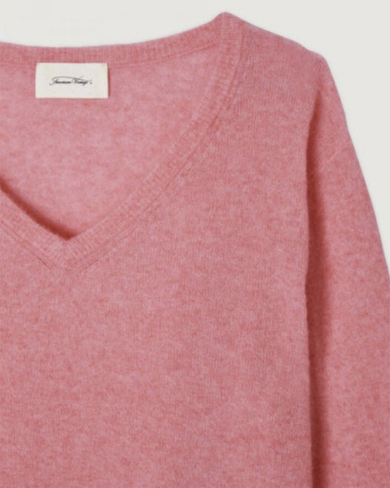 Close-up of a pink, wool blend Raz Park V Neck Sweater in Rose Bonbon with an American Vintage brand label.