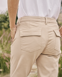 Person standing with hands in pockets, wearing Frank & Eileen Blackrock Utility Pant in Khaki.
