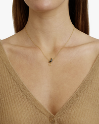 Woman wearing a Chan Luu gold necklace with a small Moon & Star Necklace in Black Mix charm.