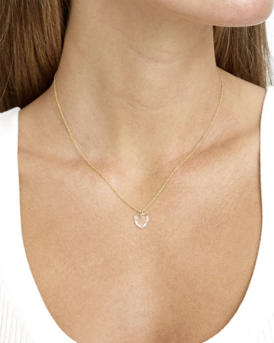 A woman wearing a delicate Chan Luu CL Necklace NG-14389 in Crystal Heart Pendant on an 18k gold plated sterling silver chain necklace.